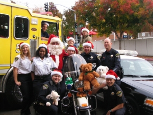 Santa Cop In front of fire truck and police motorcycle